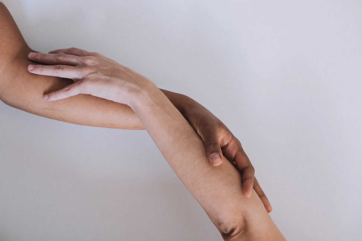 Photograph of two arms embracing